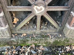 heart graffitied onto a metal grate